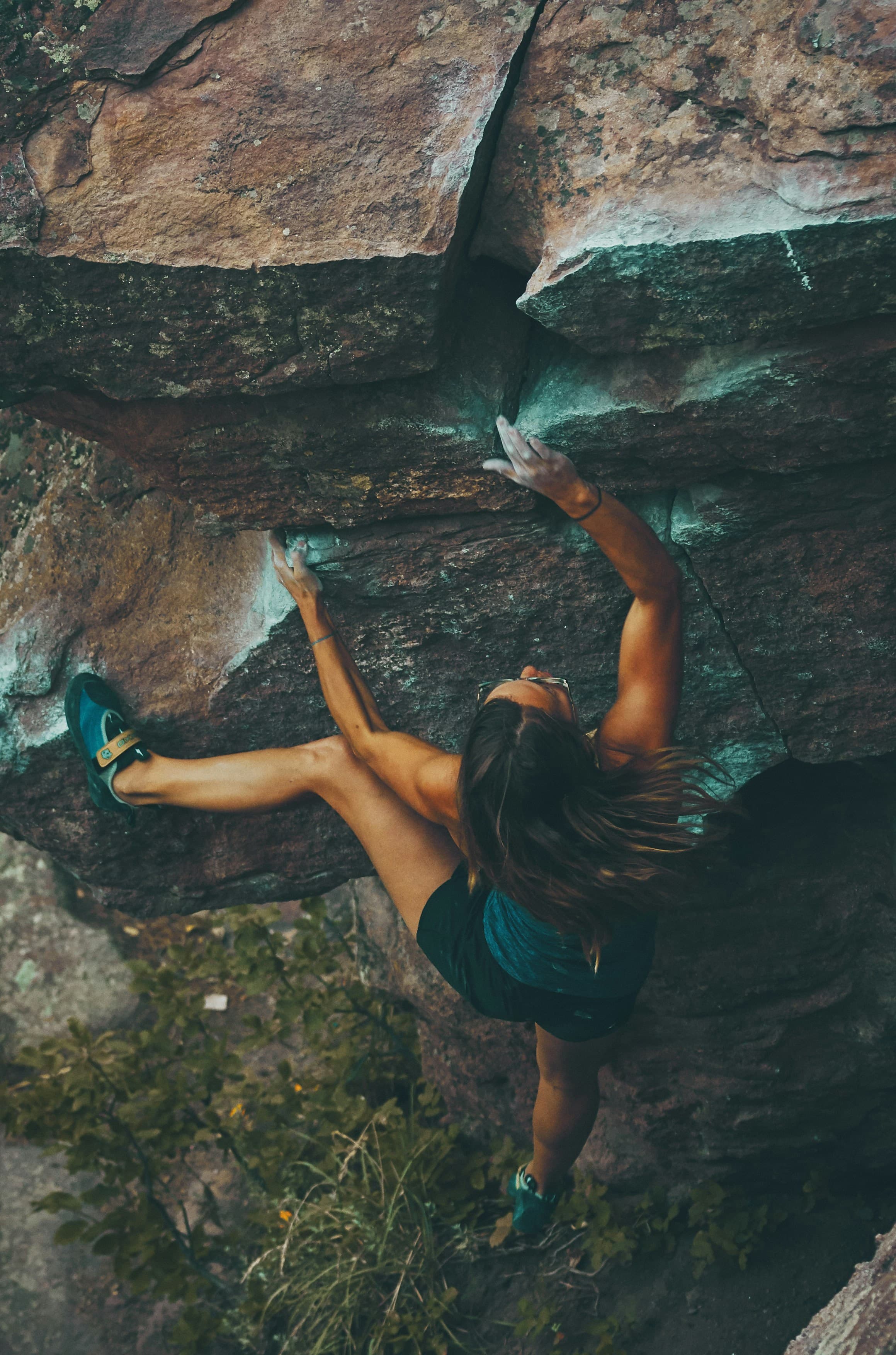 A climber mid-route on a boulder